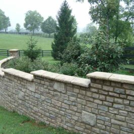 Adding the final touch to your stone retaining wall by using stone caps